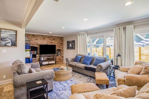 a living room with couches and a tv at Surf's Up in New Buffalo