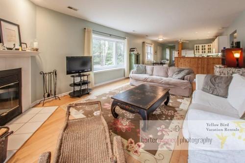 a living room with a couch and a fireplace at La Colita in Harbert