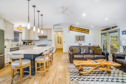 a kitchen and living room with a couch and a table at Red Pine Retreat in Thompsonville