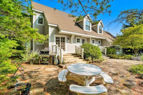 a house with a table and chairs in the yard at Blue Bear in Glen Arbor