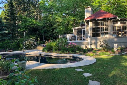 a house with a swimming pool in front of a yard at Azure Forest Pool House in Union Pier
