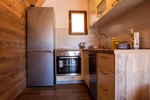 a kitchen with a stainless steel refrigerator and a sink at Bugen Villa II in Žabljak