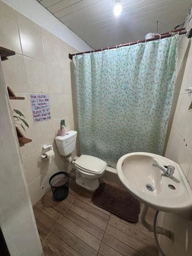 a bathroom with a toilet and a sink at Benteveo hostel iguazu in Puerto Iguazú