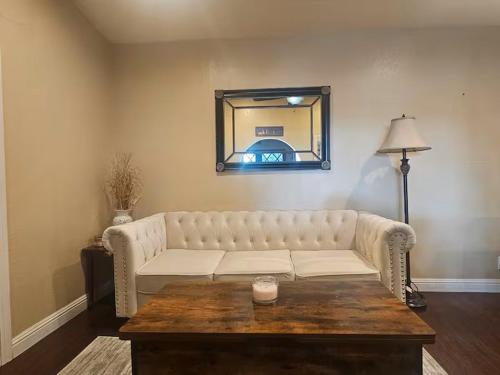 a living room with a white couch and a table at Urban Retreat -Suite A in San Jose