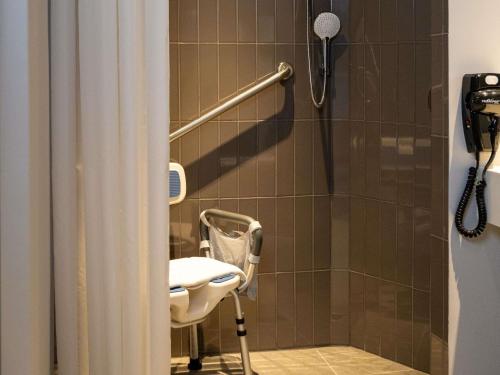 a bathroom with a shower with a toilet and a sink at Ibis Monterrey Aeropuerto in Monterrey