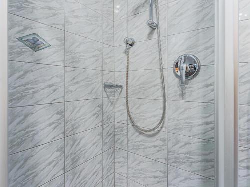 a shower with a hose in a bathroom at Igl Hof Top 2 in Westendorf