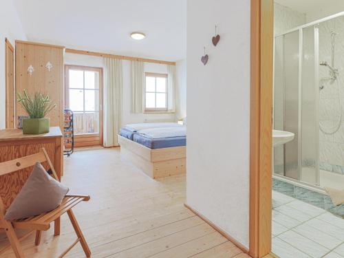 a bedroom with a bed and a bathroom with a shower at Igl Hof Top 3 in Westendorf
