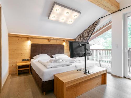 a bedroom with a bed with a television on it at Apart33 Top 1-33 Penthouse in Haus im Ennstal