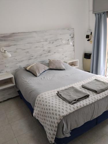 a bedroom with a large bed with a wooden headboard at Casa Esmeralda in Concordia