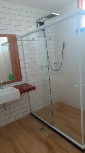 a bathroom with a glass shower and a sink at Tree Bies in Entre Rios