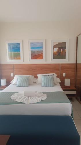 a bedroom with a large bed with two pillows at Tree Bies in Entre Rios