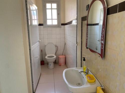 a small bathroom with a toilet and a sink at Villa Sais avec piscine in Meknès