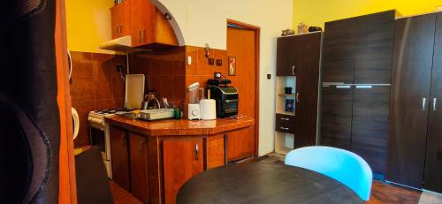 a small kitchen with a table and a refrigerator at Modest Ultra Central Apartment Council Square in Braşov