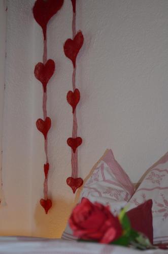 a group of red hearts hanging on a wall at Appartementhaus Eberharter in Hart im Zillertal