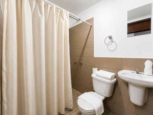 a bathroom with a toilet and a sink at Hotel Valle del Huajucar in Calvillo