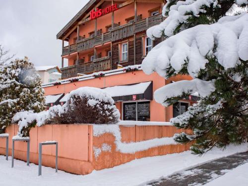 a building in the snow with snow covered trees at ibis La Bresse Gérardmer in La Bresse
