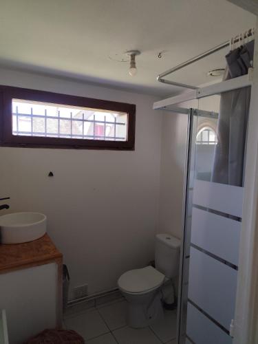 a bathroom with a toilet and a sink and a window at Tableaux in Château-Renault