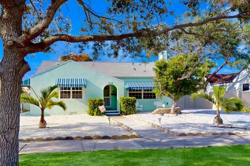a house with a tree in front of it at Vintage Venice Duplex - A in Venice
