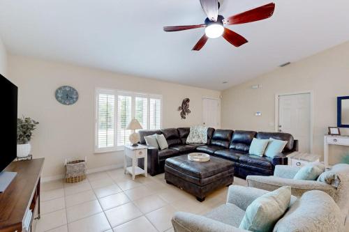 a living room with a couch and a ceiling fan at No Regrets in Englewood