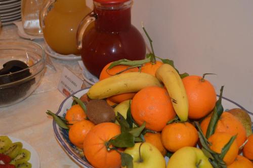 a bowl of fruit with bananas and oranges on a counter at Hotel L'Antico Convitto in Amalfi