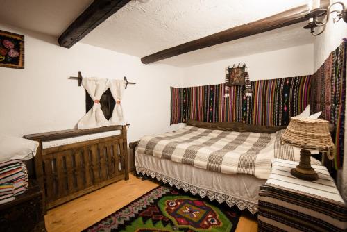 a bedroom with a bed and a rug at Pension La Roata in Gura Humorului