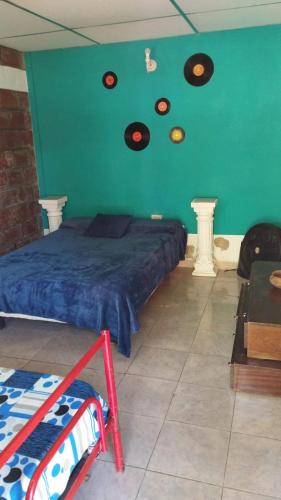 a bedroom with a bed with records on the wall at 7 duendes in Salta