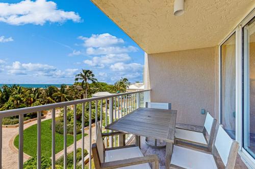 a balcony with a table and chairs and the ocean at Marco Beach Ocean Resort 801 in Marco Island