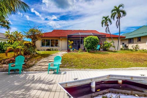 two chairs sitting on a patio in front of a house at Marco Island Manor in Marco Island