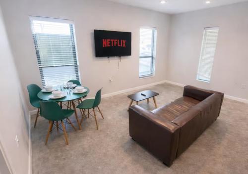 a living room with a couch and a table at Cozy Greenwood Canopy in Des Moines