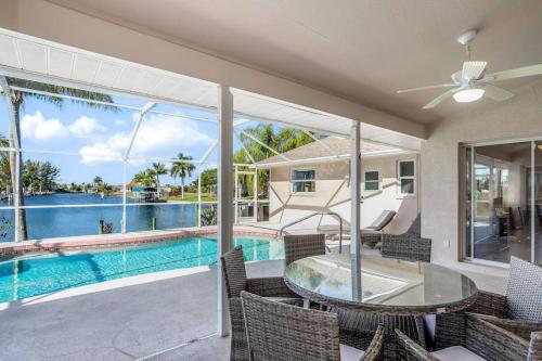 a patio with a table and chairs and a swimming pool at Hook, Line, and Sunsets in Port Charlotte