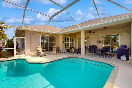 a swimming pool in front of a house at Endless Summer in Cape Coral