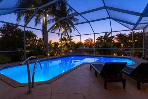 a swimming pool with a tent over it at night at Endless Summer in Cape Coral