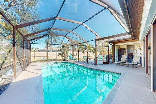 a swimming pool in a house with a glass ceiling at Cape Escape in Cape Coral