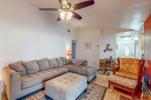 a living room with a couch and a ceiling fan at Cape Escape in Cape Coral