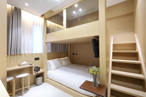 a small bedroom with a bunk bed and a desk at Busan Seomyeon Nestly Hotel in Busan