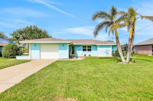 a house with a palm tree in a yard at Three Palms Retreat in Cape Coral