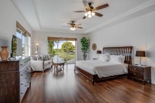 a bedroom with a bed and a ceiling fan at Sable Retreat in Cape Coral