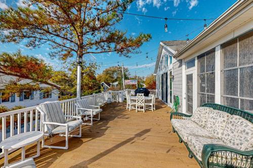 a porch with benches and tables on a house at Rehoboth Beach --- 21163 Bayview Rd. in Dewey Beach