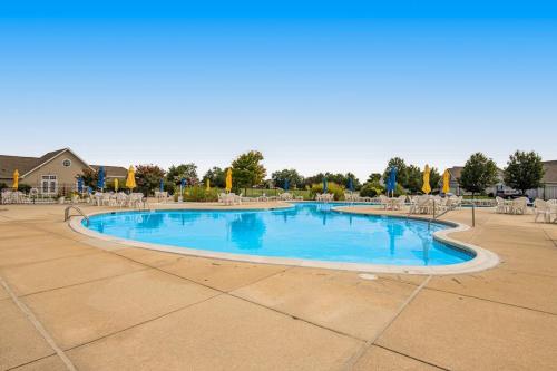 a large swimming pool with chairs and blue water at Bethany Bay --- 37182 Harbor Dr #2606 in Ocean View
