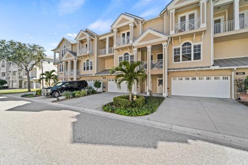 a large apartment building with a car parked in the driveway at White Coral in Placida