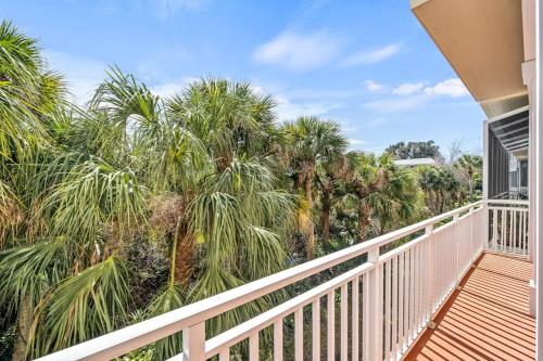 a balcony of a house with palm trees at White Coral in Placida