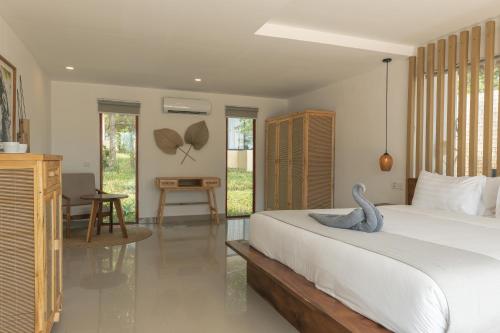 a bedroom with a bed with a blue swan on it at Anaya Koh Rong in Koh Rong Island
