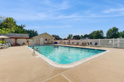 a large swimming pool with people in the water at Moose's House --- 70 Radcliffe Rd. in The Plantations