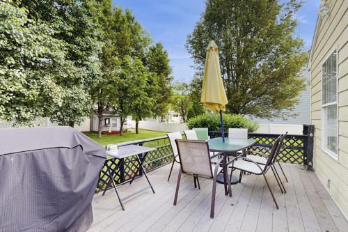 a patio with a table and a yellow umbrella at Moose's House --- 70 Radcliffe Rd. in The Plantations