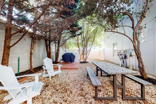 a patio with a table and chairs and trees at Rehoboth Beach -- Forj Lofts #8 in Rehoboth Beach