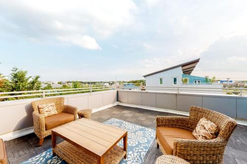 a patio with chairs and a table on a balcony at Rehoboth Beach -- Forj Lofts #8 in Rehoboth Beach