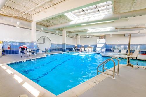 a large swimming pool with blue water at Sea Colony --- 2403 Round Robin in Bethany Beach
