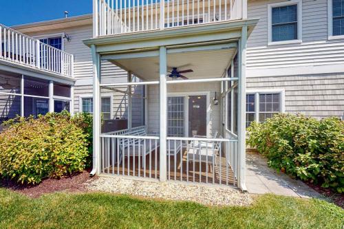 a screened in porch of a house with a fan at The Tides --- 19979 Sandy Bottom Cir, Unit #502 in Rehoboth Beach