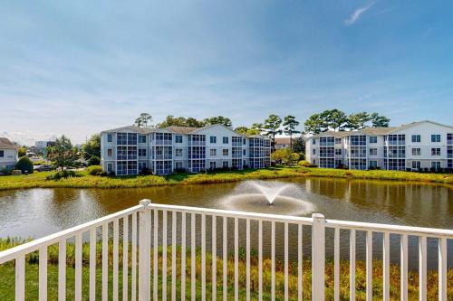 a fountain in a pond in front of apartment buildings at The Tides --- 19979 Sandy Bottom Cir, Unit #502 in Rehoboth Beach