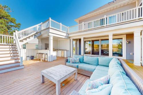 a living room with a couch and a table on a deck at Watermark North --- 38918 Silver Sands Dr in Bethany Beach